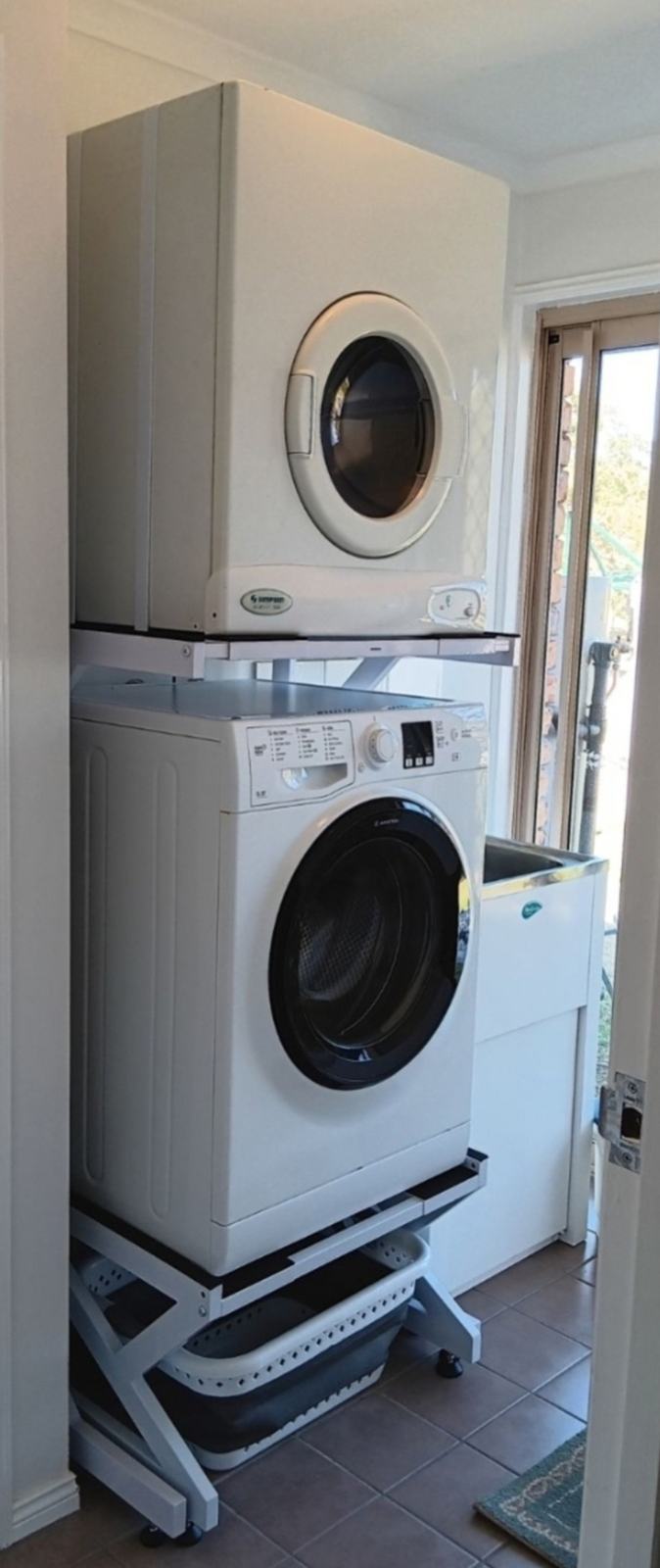 Real Space showing a DryerStand freestanding tumble dryer stand in a real laundry space with a dryer above a washing machine