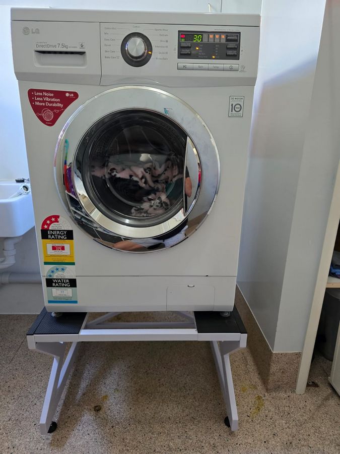 Real Space Washerbase showing a DryerStand freestanding tumble dryer stand in a real laundry space with a dryer above a washing machine