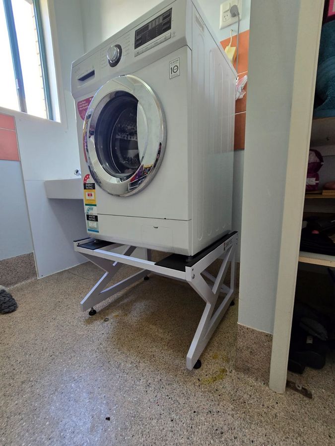 Real Space Washerbase showing a DryerStand freestanding tumble dryer stand in a real laundry space with a dryer above a washing machine