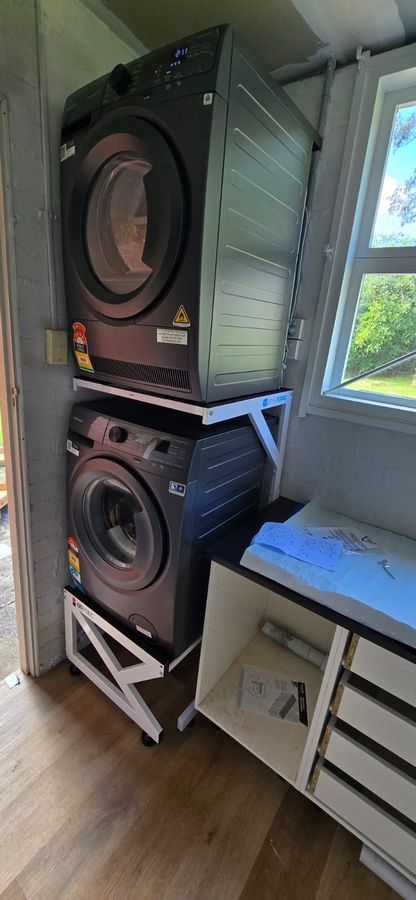 Real Space Combo showing a DryerStand freestanding tumble dryer stand in a real laundry space with a dryer above a washing machine