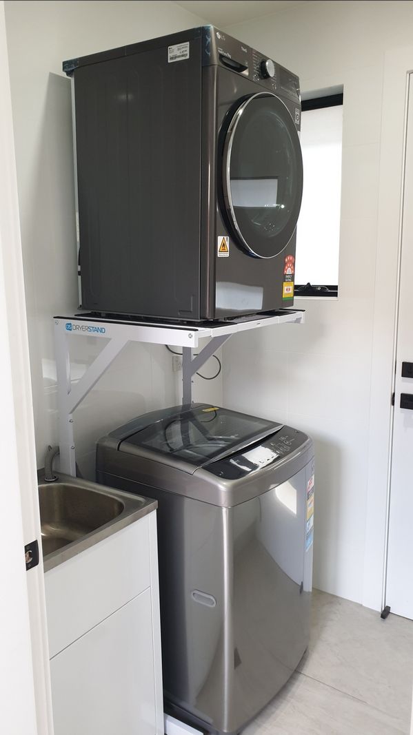 Real Space Combo showing a DryerStand freestanding tumble dryer stand in a real laundry space with a dryer above a washing machine