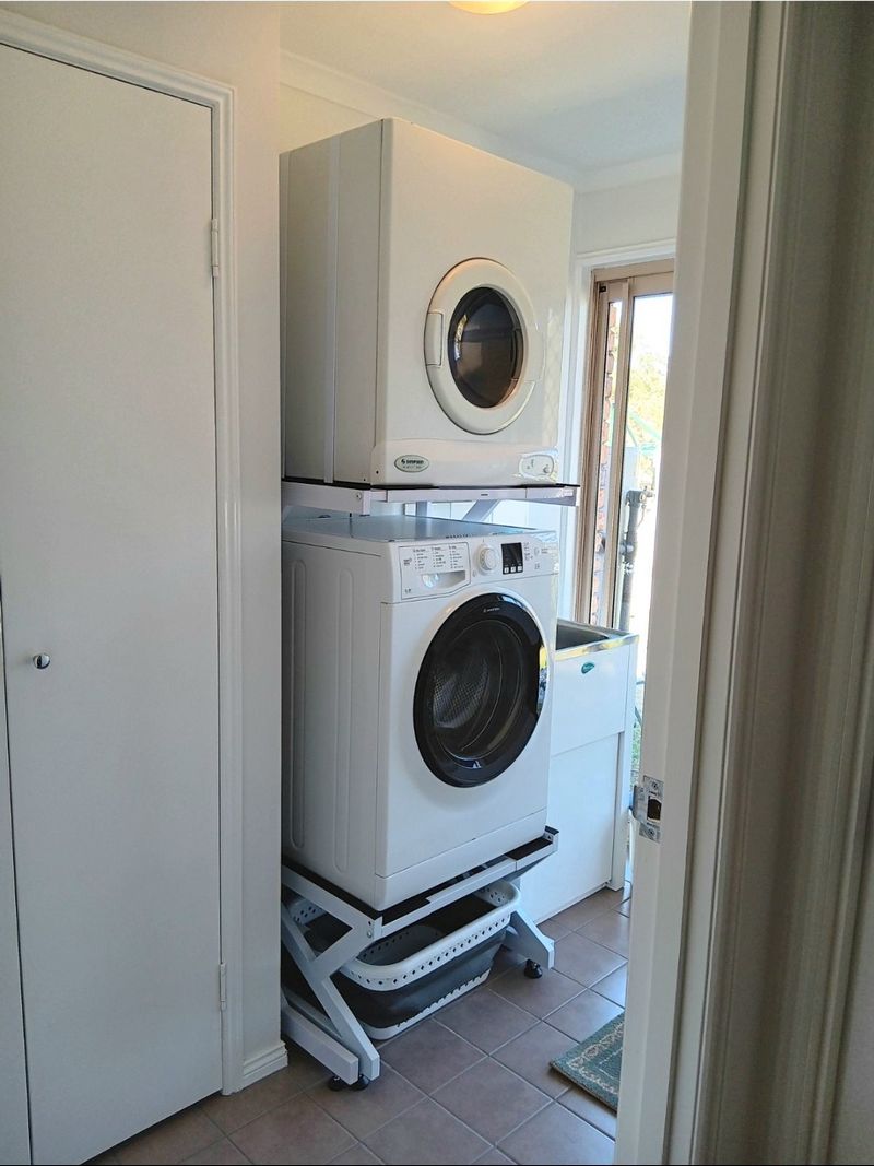 Real Space Combo showing a DryerStand freestanding tumble dryer stand in a real laundry space with a dryer above a washing machine