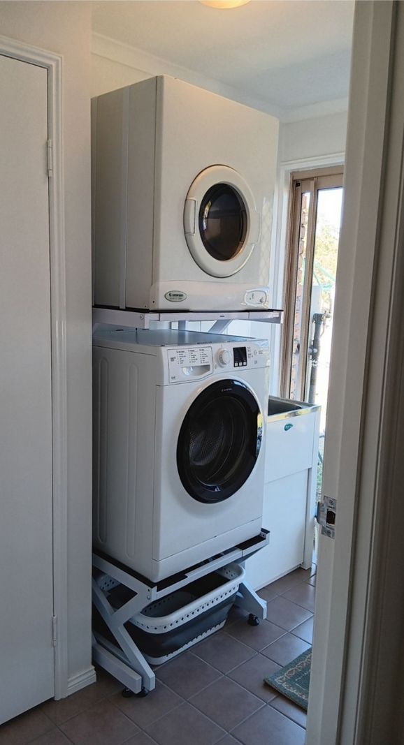 Real Space Combo showing a DryerStand freestanding tumble dryer stand in a real laundry space with a dryer above a washing machine